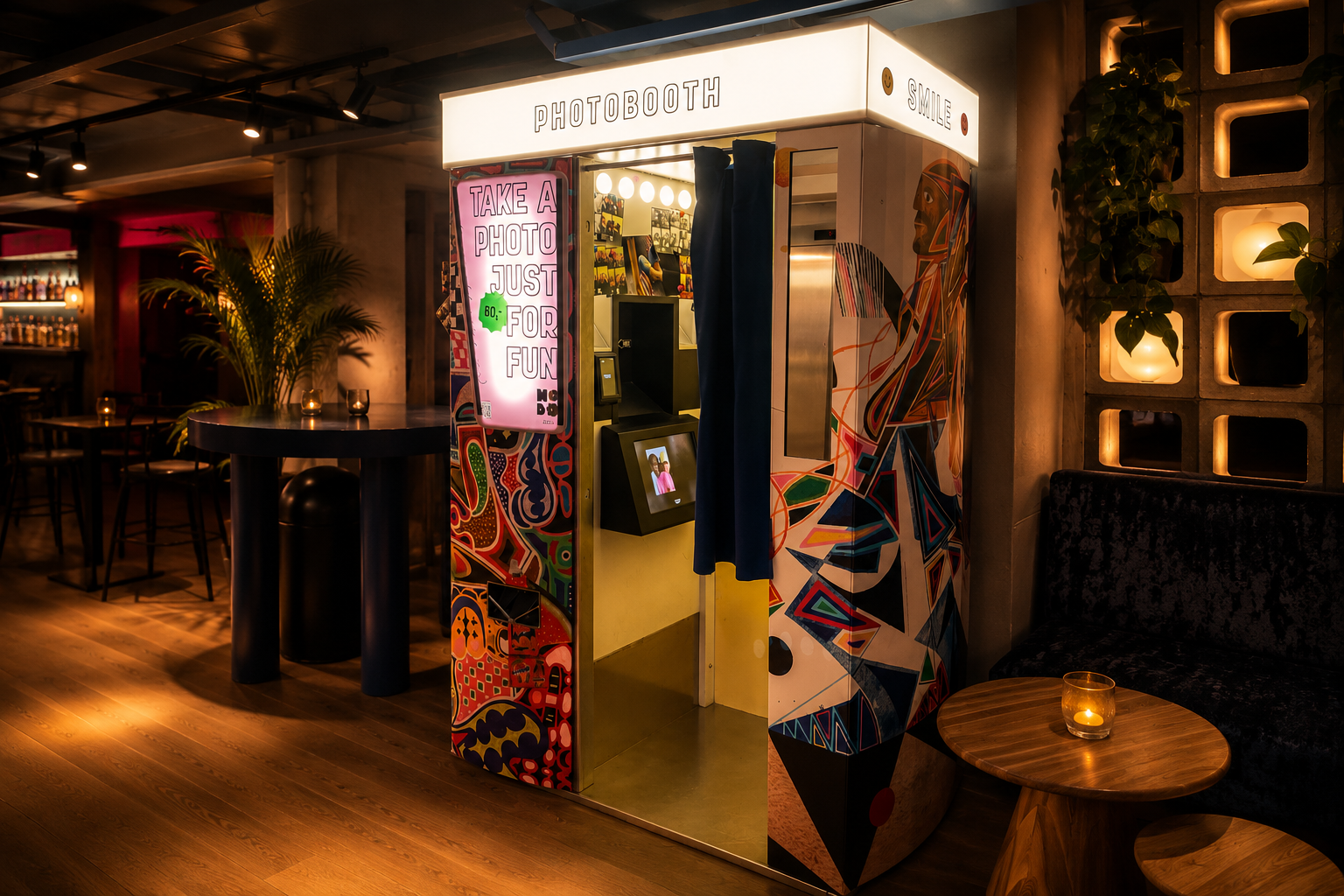 Fun Booth photo booth installed at HOBO Oslo by Strawberry — dimly lit lounge with bar, plants and stone shelving.